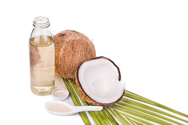 istock Cold pressed extra virgin coconut oil in bottles with coconuts 528052788