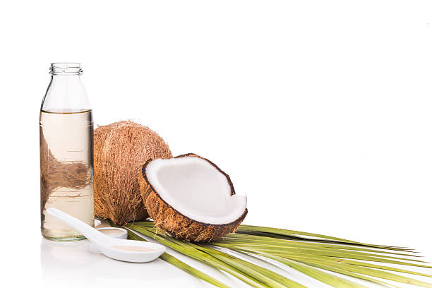 istock Cold pressed extra virgin coconut oil in bottles with coconuts 528052814