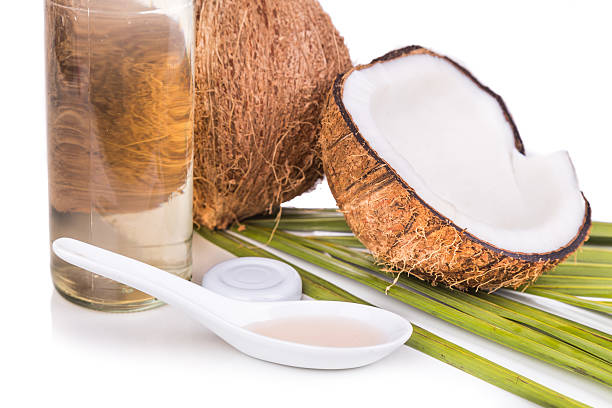 istock Cold pressed extra virgin coconut oil in bottles with coconuts 528052854