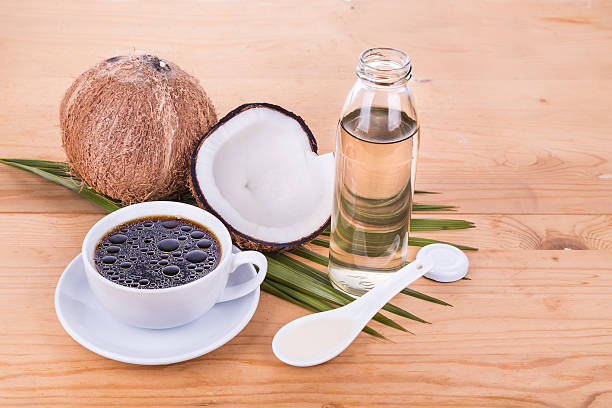 istock Bulletproof coffee with virgin coconut oil on wooden table 528053040