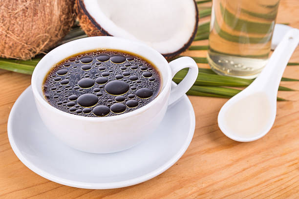Bulletproof coffee with virgin coconut oil on wooden table