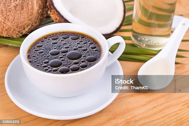 Bulletproof Coffee With Virgin Coconut Oil On Wooden Table Stock Photo - Download Image Now