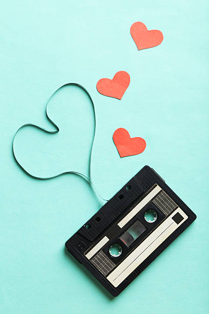 istock Audio tape cassette on mint paper background 528054274