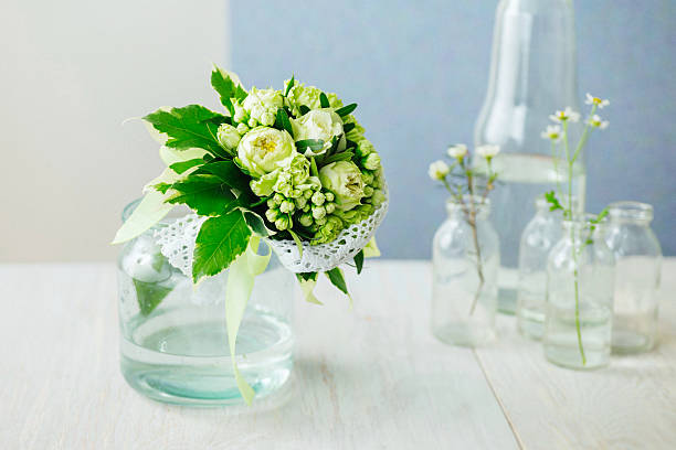 istock Green cream wedding bouquet with roses and weeping fig leaves. 528054674
