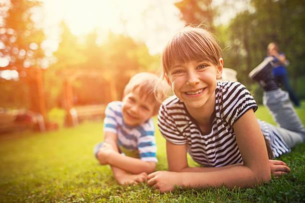 istock Brother and sister having fun on garden lawn 528054896