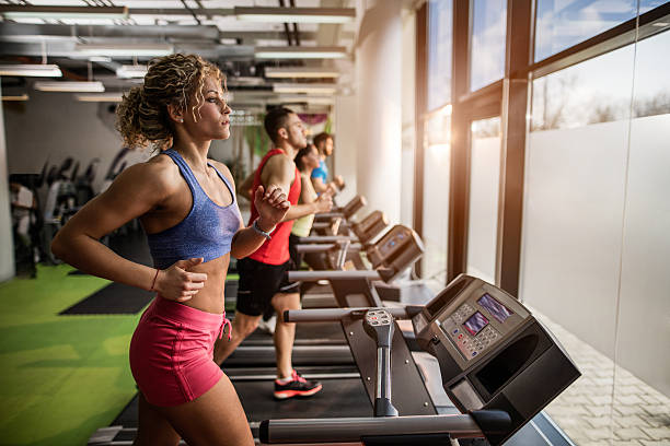 istock People exercising on treadmills in a gym. 528055868