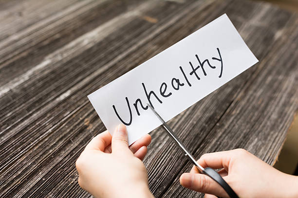 istock holds card with text unhealthy on old wood plank 528057372