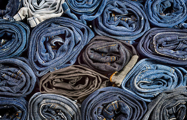 istock Lot of different blue jeans close-up, background 528059372
