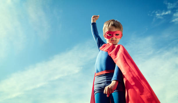 Superhero kid in red cape and mask Superhero child concept for childhood, imagination and aspirations cape garment photos stock pictures, royalty-free photos & images