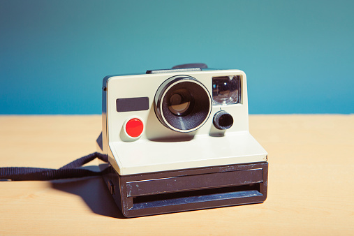 Old instant camera isolated on a table