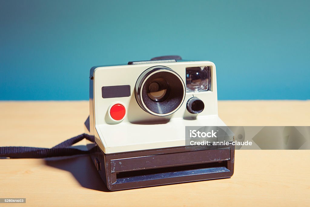 Vintage photography Old instant camera isolated on a table Instant Camera Stock Photo