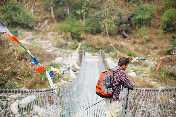 istock Hindi hiker on suspension footbridge 528064794