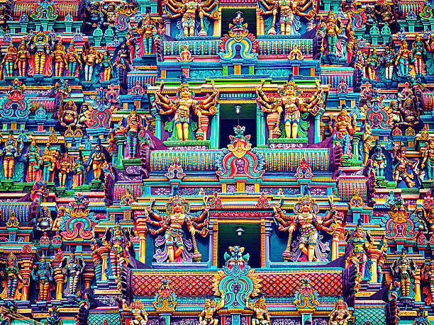 Sculptures on Hindu temple tower Vintage retro effect filtered hipster style image of statues on Hindu temple gopura (tower). Menakshi Temple, Madurai, Tamil Nadu, India dravidian culture photos stock pictures, royalty-free photos & images