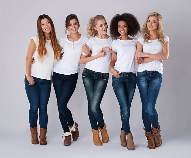 istock Multi ethnic friends wearing jeans and white t-shirts 528065135