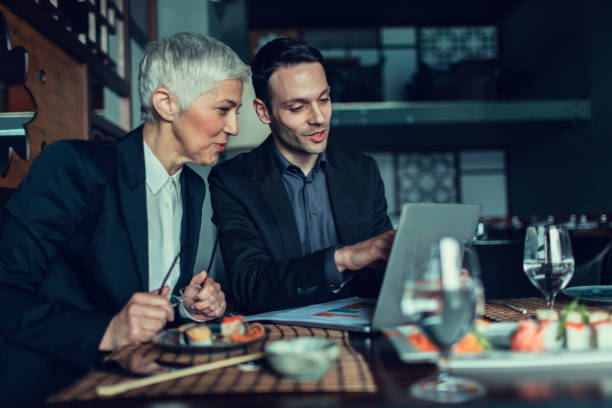 istock Businesspeople Having Meeting and Lunch In A Restaurant. 528065522