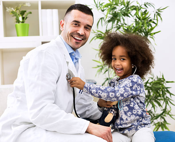 istock Smiling pediatrician and his happy little patient 528065638