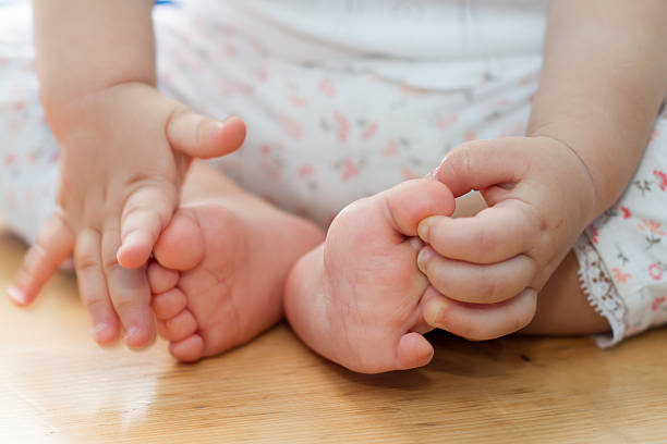 istock One year old old baby hands and feet closeup 528065778