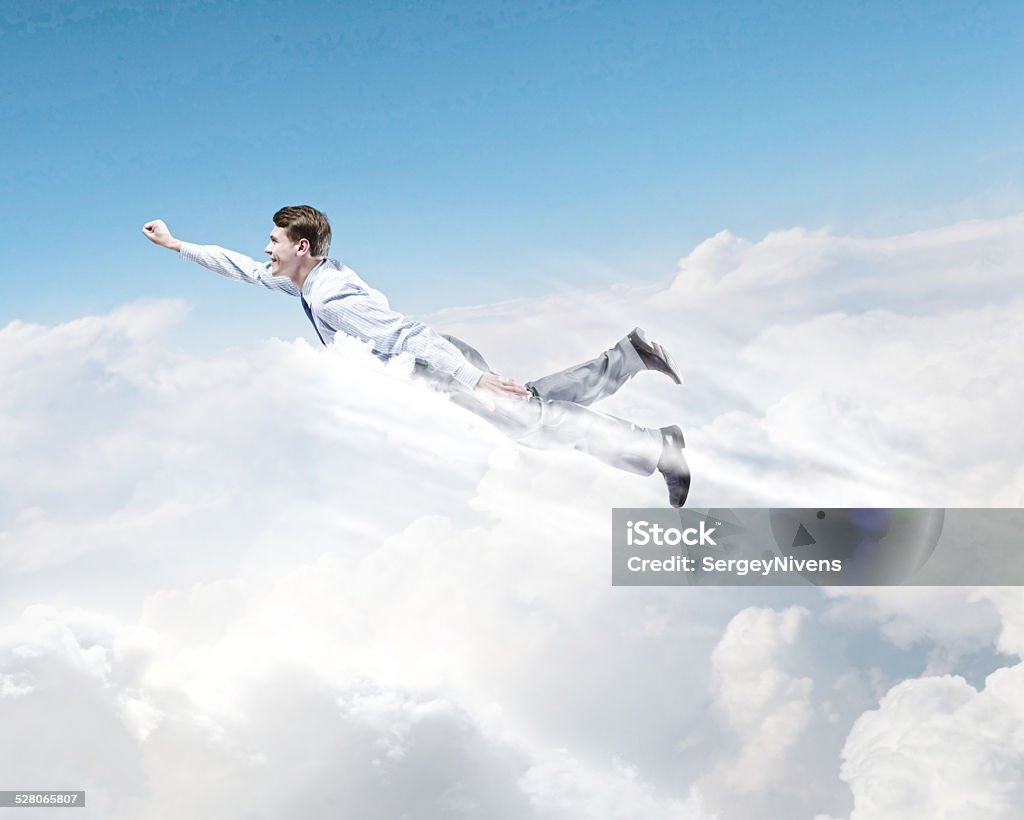 Flying businessman Young super businessman flying high in sky Achievement Stock Photo