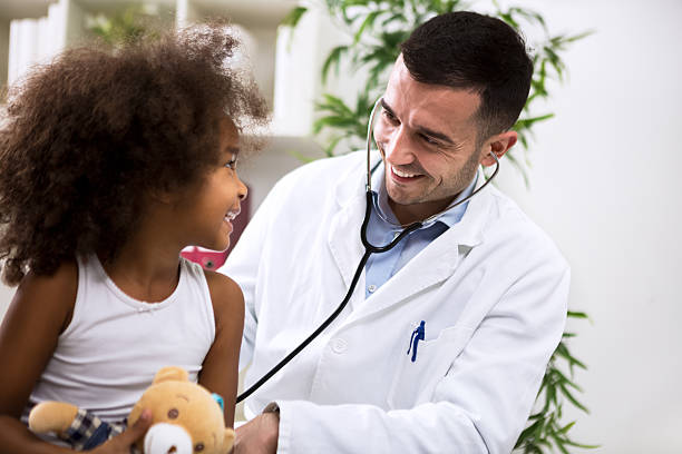 istock Positive pediatrician doctor examining kid 528066014