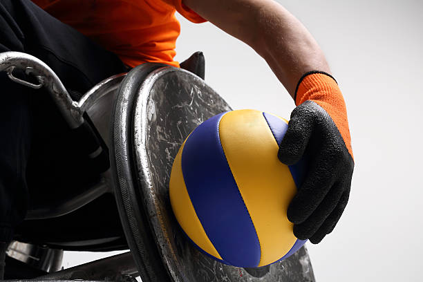 The man on the sports wheelchair with the ball 