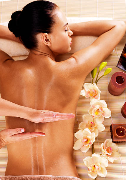 istock Masseur doing massage on woman back in spa salon 528068611