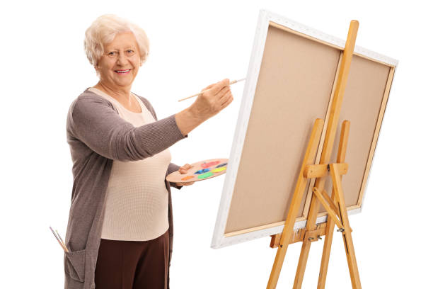 istock Senior lady painting on a canvas 528069188