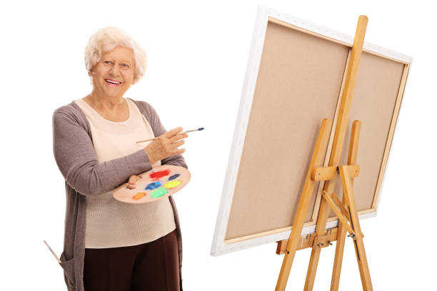 istock Senior lady posing next to a canvas 528069274