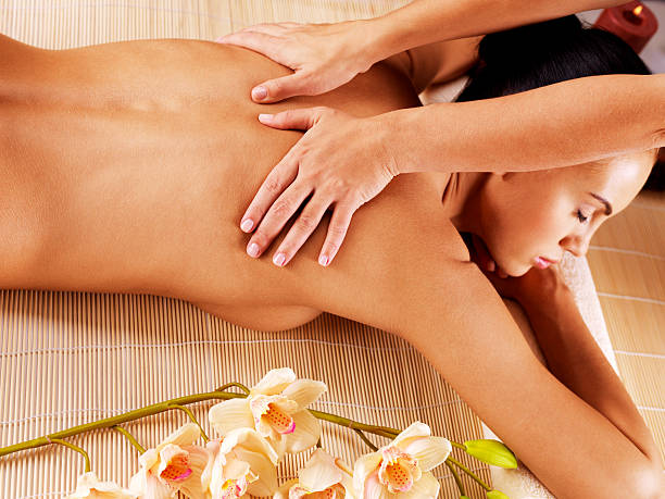 istock Masseur doing massage on woman back in spa salon 528069571