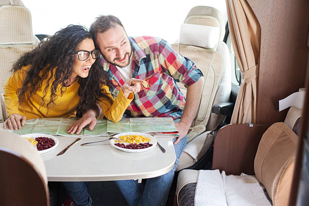 istock Young couple dining inside of caravan 528070080