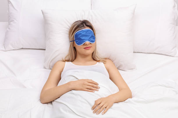 istock Woman sleeping with blue eye mask 528071234
