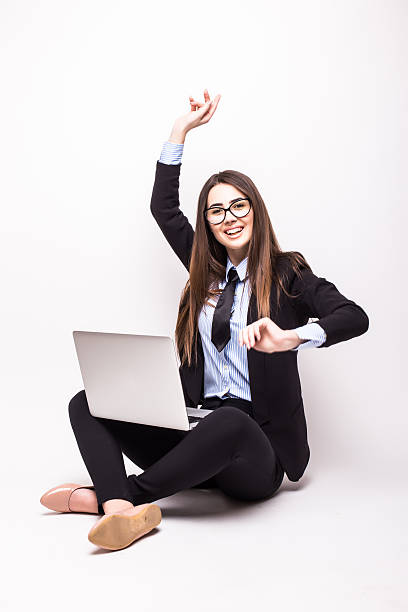istock young woman with laptop computer celebrating success, isolated on white. 528071380