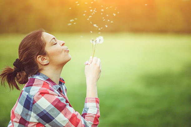 istock Woman with dandelion 528071480