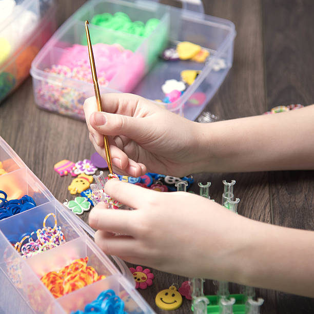 istock children's hands are weaving figures out colored rubbers 528072750