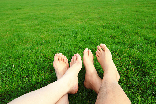 Couple Relax barefoot enjoy nature in the green lawn