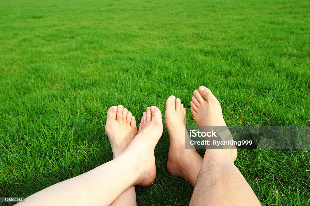 Couple Relax barefoot enjoy nature Couple Relax barefoot enjoy nature in the green lawn Grass Stock Photo