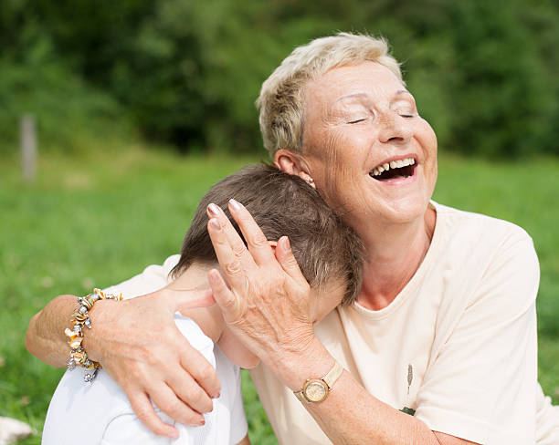 istock Grandmother caressing and hugging grandson 528101253