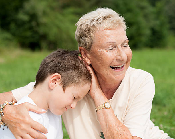istock Grandmother caressing and hugging grandson 528101267