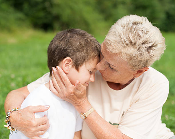 istock Grandmother caressing and hugging grandson 528101271
