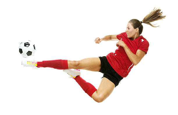 istock Female soccer player kicking the ball 528102657