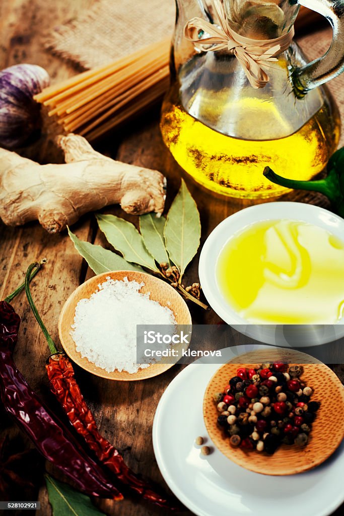 Olive Oil and Spices Olive Oil and Spices on wooden table Basil Stock Photo