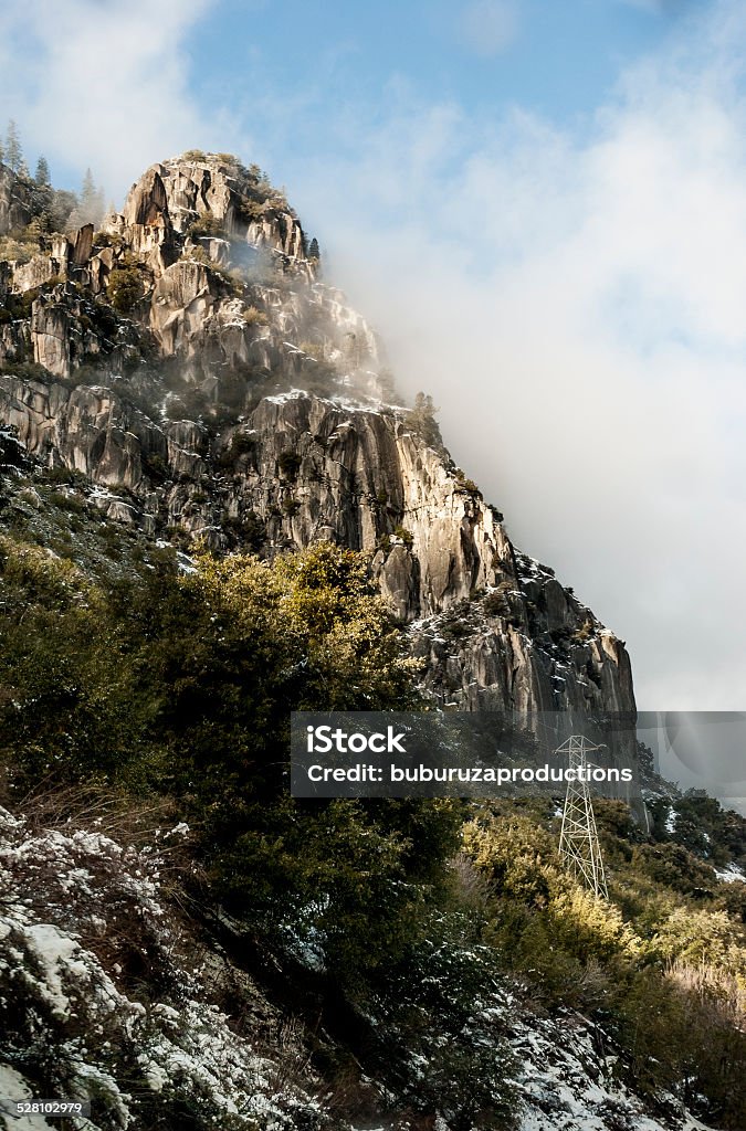 Clouds in the Mountains Snow dusted mountains touch the clouds in California's Yosemite National Park Cable Stock Photo