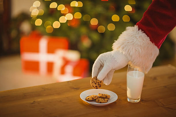 istock Hand of santa claus picking cookie 528103017