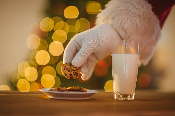 istock Hand of santa claus picking cookie 528103029