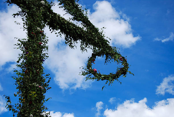 istock Detail of midsummer pole at blue sky with white clouds 528104269