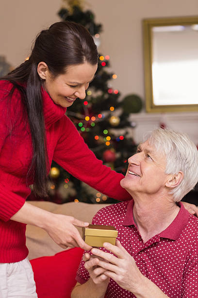 istock Mother offering gift to grandfather 528106901
