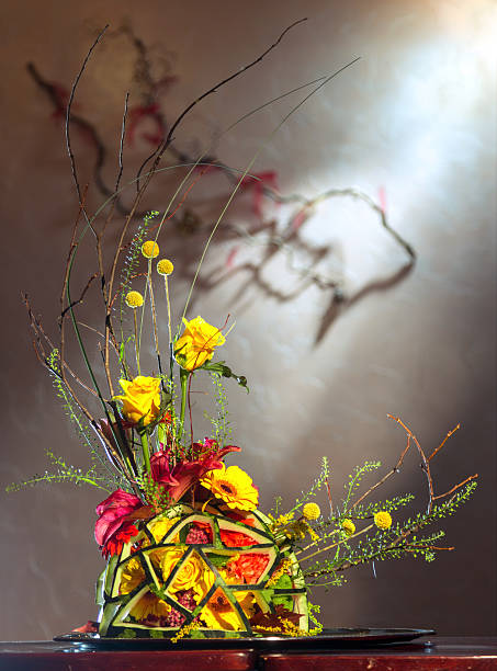 Flower arrangement in Japanese style in a carved watermelon vase