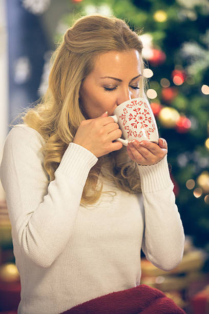 istock Woman drinking hot drink on Christmas eve 528107175