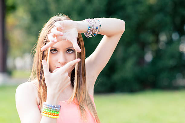 istock Portrait of beautiful young woman making frame with her hands. 528107301