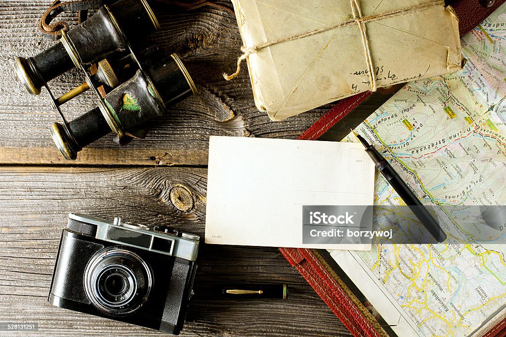 letter from travel letter from travel concept - old map holder, camera and binoculars Diary Stock Photo