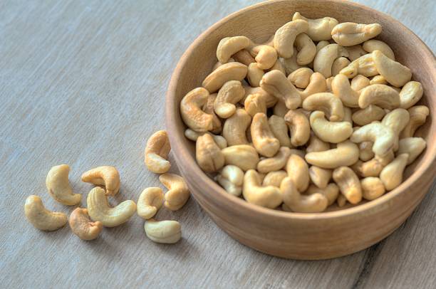 istock Cashews In Wooden Bowl 528131563